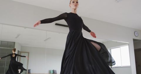 Graceful Female Ballet Dancer Performing in Studio
