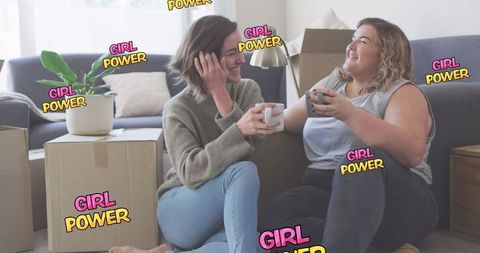 Young Women Celebrating Friendship Amidst Moving Boxes