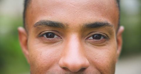 Close-up portrait of man in park focusing on eyes