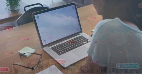 Woman Typing at Office Table with Digital Data Overlays