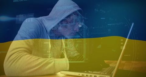 Hacker engaged in cyber warfare with overlay of ukraine flag