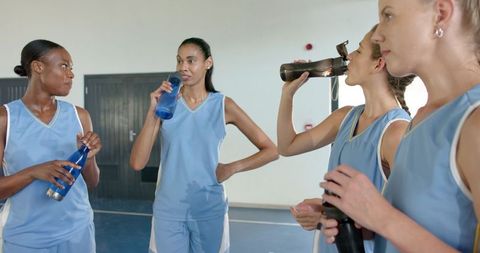 Diverse Female Basketball Players Refreshing on Court