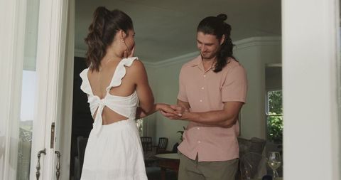Joyful home proposal with engaged couple sharing moment