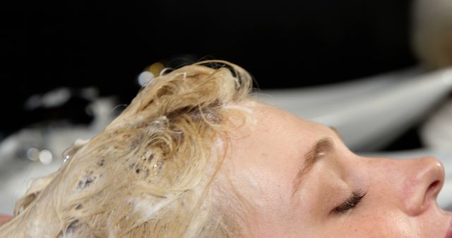 Woman Relaxing While Getting Hair Shampooed at Salon - Download Free Stock Images Pikwizard.com