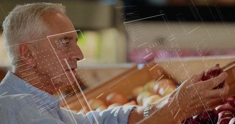 Man choosing fresh apples at grocery store, healthy lifestyle