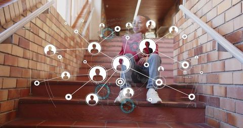 Teen Boy Relaxing on Urban Brick Stairs with Digital Interface Concept