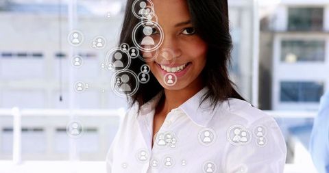 Smiling businesswoman engaged with digital network icons