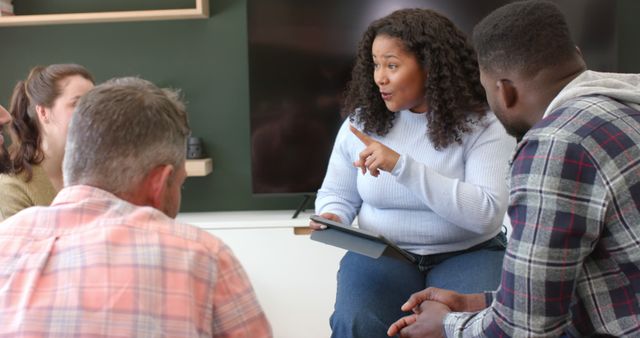 Woman Leading Discussion with Group in Casual Setting - Download Free Stock Images Pikwizard.com