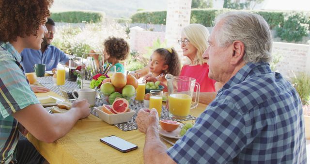 Multigenerational Family Enjoying Outdoor Breakfast Together - Download Free Stock Photos Pikwizard.com