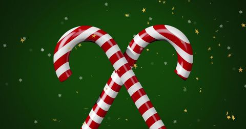 Festive candy canes and stars on green christmas background