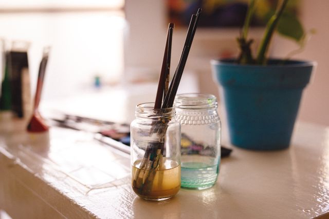 Dirty Brushes in Jar on Desk in Art Studio - Download Free Stock Photos Pikwizard.com