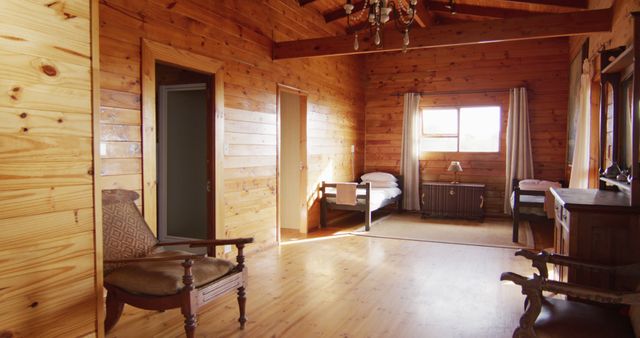 General view of bedroom with beds and armchairs in log cabin, slow motion - Download Free Stock Photos Pikwizard.com