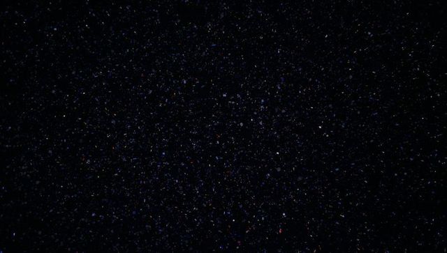 Digital Noise Effect with Multicolored Flecks on Dark Background