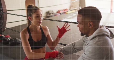 Boxer Engaging in Motivational Talk inside Gym Ring