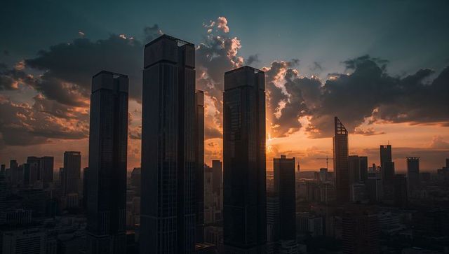 Sunset reflecting on glass skyscrapers creating dramatic skyline silhouettes and clouds