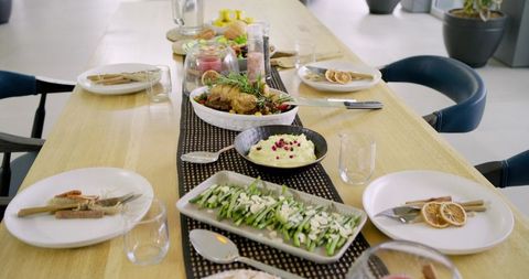Modern Minimalist Dining Table Featuring Roast Chicken, Asparagus Platter and Seasonal Tableware