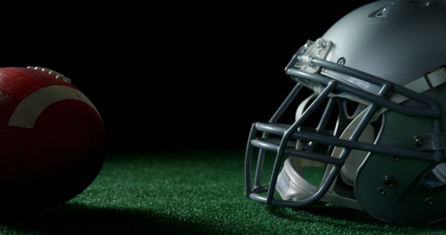 American Football Helmet and Ball on Turf with Black Background - Download Free Stock Images Pikwizard.com