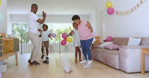 Family Teamwork Cleaning Living Room Together with Joy