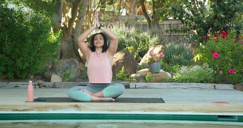 Woman practicing yoga outdoors achieving inner peace