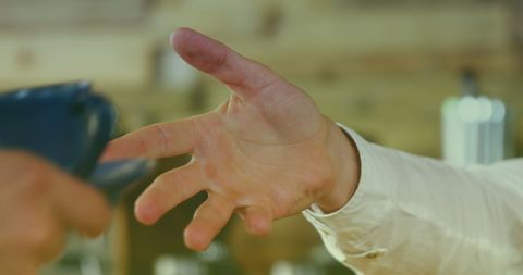 Friendly Barista Handing Beverage to Customer
