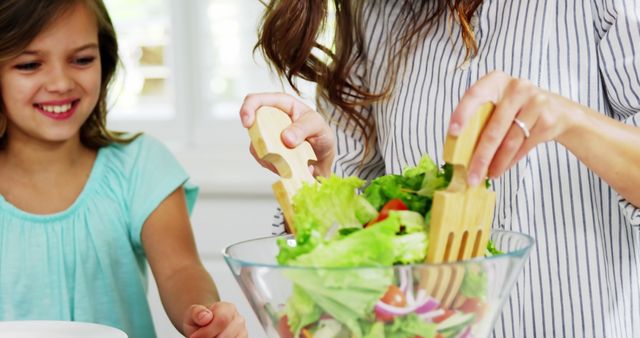 Mother and Daughter Preparing Fresh Salad in Kitchen - Download Free Stock Images Pikwizard.com