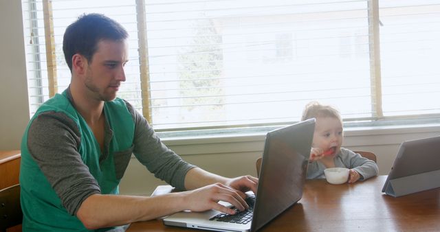 Father Working on Laptop with Child Using Tablet - Download Free Stock Images Pikwizard.com