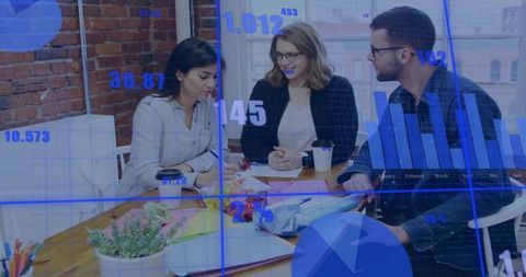 Young professionals collaborating over charts and coffee at urban brick office table