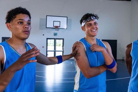 Basketball Teammates Resting and Socializing on Indoor Court