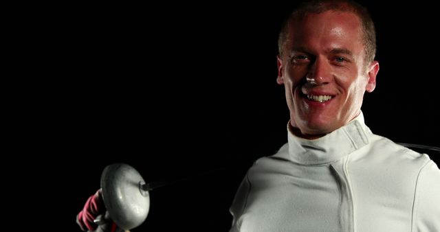 Confident Fencer Holding Epee Sword in Dark Background - Download Free Stock Images Pikwizard.com