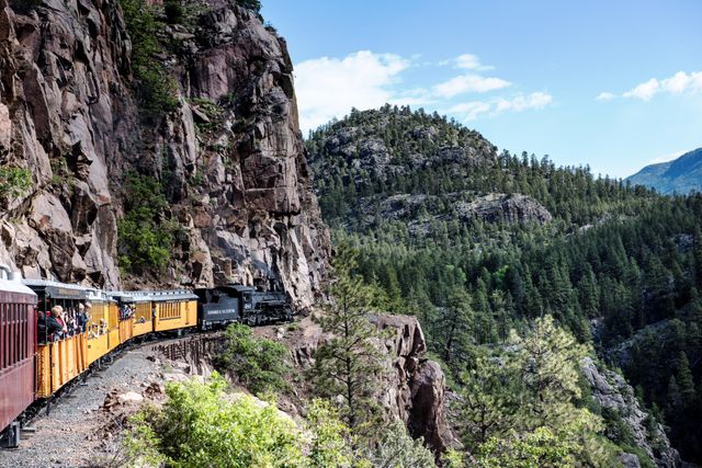 Historic steam train traveling through lush mountain landscape - Download Free Stock Photos Pikwizard.com
