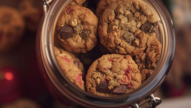 Homemade chocolate chip cookies in decorative glass jar