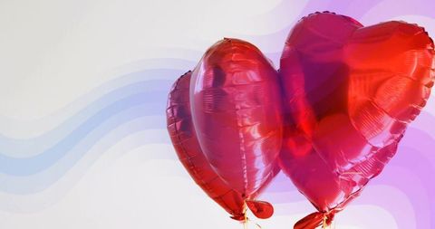 Floating red heart balloons against pastel wave gradient background for valentine design