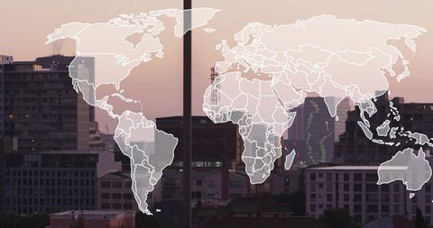 Translucent world map overlay on urban skyline at dusk for global business concept