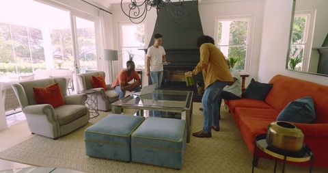 Friends Gathering in Cozy Living Room Sharing Laughter and Drinks