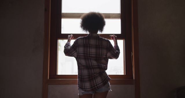 Youthful Woman In Plaid Shirt Looking Out Window - Download Free Stock Images Pikwizard.com