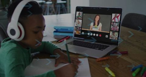 Young Boy Engaging in Remote Learning with Headphones and Laptop
