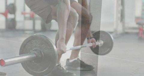 Close-Up Athlete Gripping Barbell Preparing Deadlift in Gym with Plate Foreground