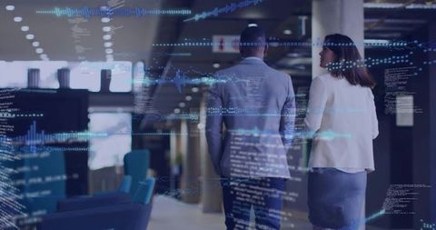 Two Professionals Walking and Discussing Plans in Modern Office Corridor With Digital Data Overlay