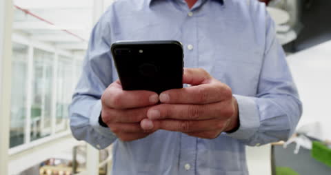 Businessman Using Smartphone in Modern Office