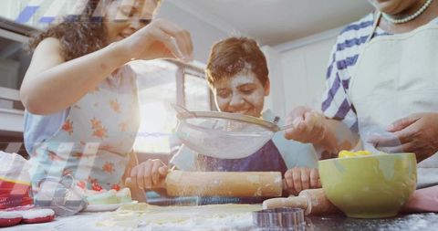 Grandma guiding boy rolling dough while mom sifting flour multigenerational family baking
