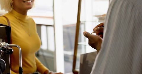 Woman Ordering Coffee in Cozy Café