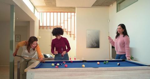 Multicultural Friends Playing Pool in Bright Modern Game Room, Casual Social Gathering