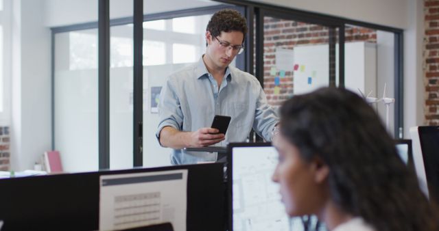 Businessman Using Smartphone in Modern Office with Brick Walls - Download Free Stock Images Pikwizard.com