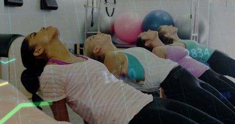 Synchronized Bridge Exercise Class Arching Backs Strengthening Core with Stability Balls