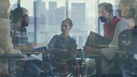 Cityscape Overlay on Business Team Meeting in Office