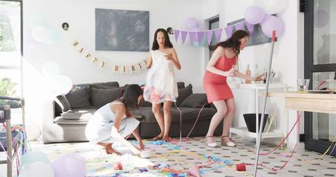 Diverse Friends Cleaning After Birthday Celebration