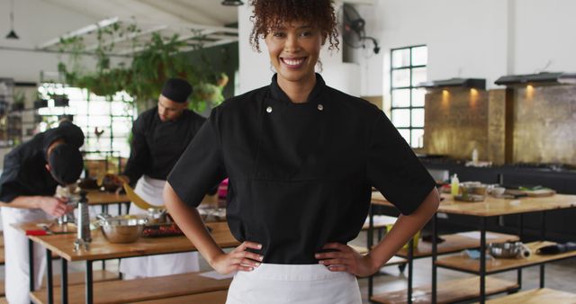 Confident Female Chef Smiling in Modern Kitchen - Download Free Stock Images Pikwizard.com