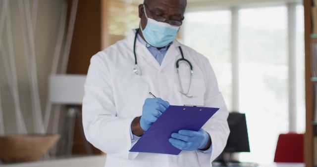 Senior African American Doctor Writing on Clipboard Wearing Medical Mask - Download Free Stock Images Pikwizard.com