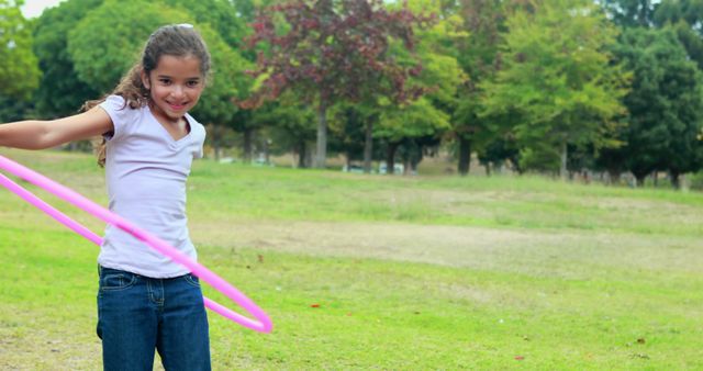 Young Girl Enjoying Summer Fun with Hula Hoop in Park - Download Free Stock Images Pikwizard.com