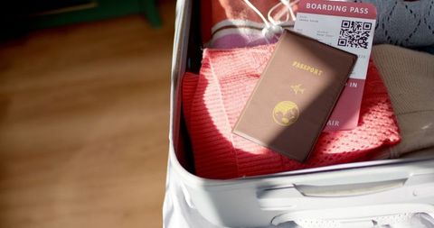 Open suitcase with passport boarding pass ready for travel